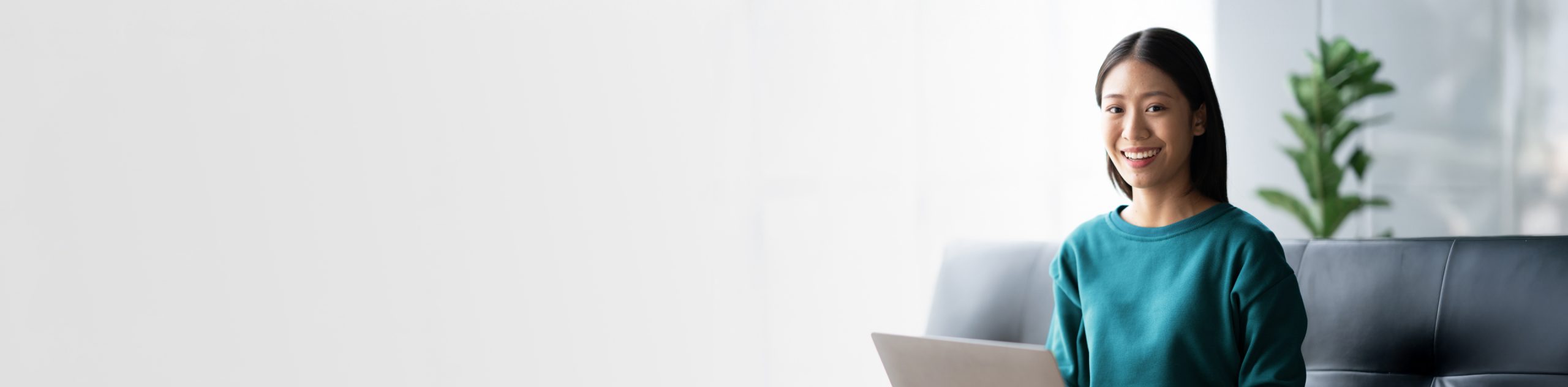 woman with laptop smiling at camera